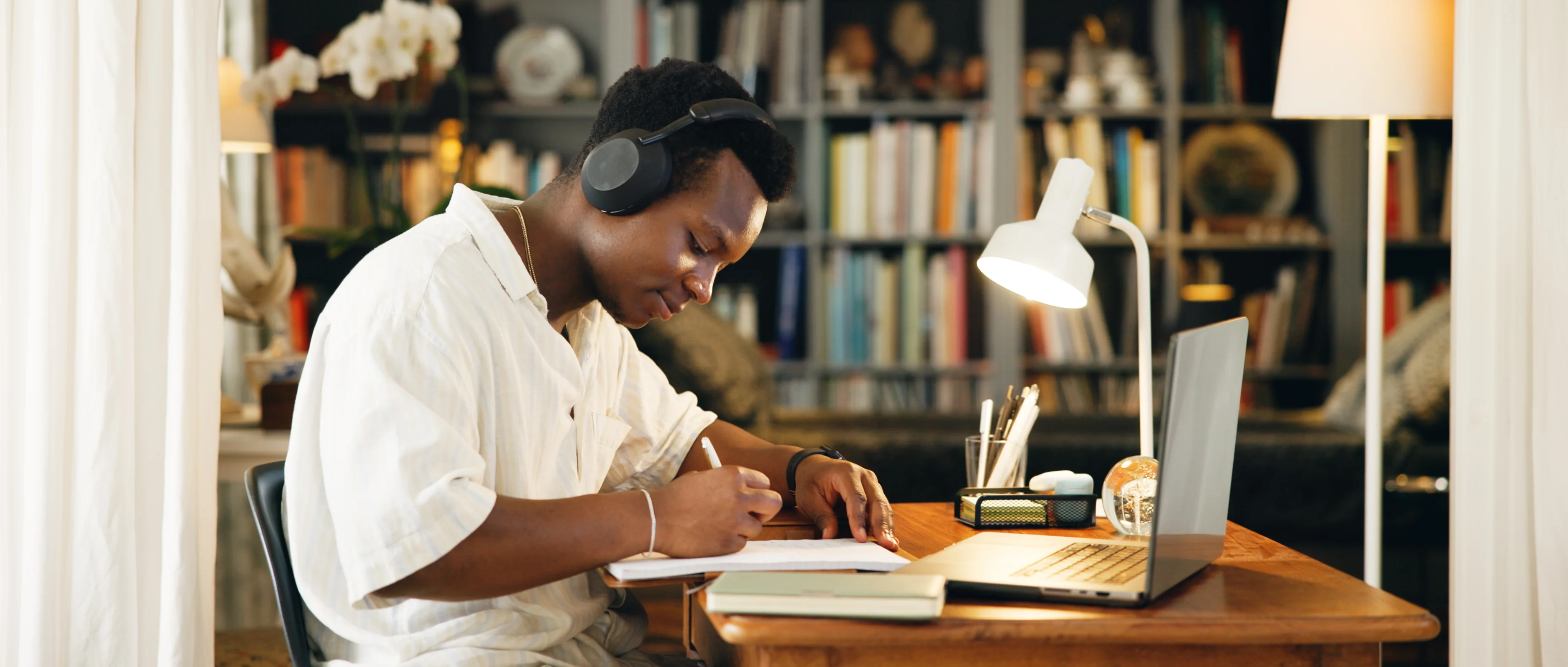 Person studying at a desk with headphones.